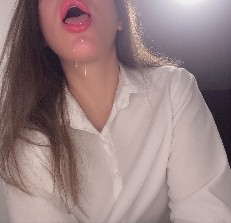 With a delicious, sensual expression, the professor’s pinkish lips glisten with a droplet of saliva, her face an invitation to the man standing nearby, full of erotic tension